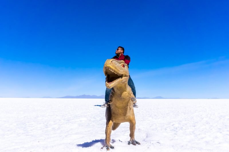 The Man of Wonders riding a T-Rex at the Salar de Uyuni